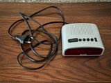 a radio and a charger sitting on a wooden table