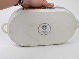 a person holding a white container with food inside of it