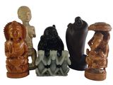 four figurines of different shapes and sizes on a white background