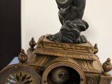 a bronze statue of a boy on top of a cart