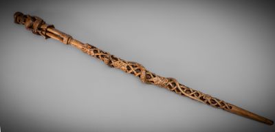 an old wooden stick with carvings on it sitting on a table
