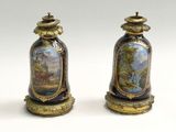 two vases with paintings on them sitting on a white surface