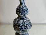 a blue and white vase sitting on top of a glass table