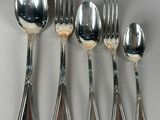 five silver spoons and six silver spoons on the table