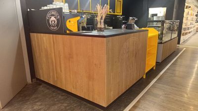 un café avec un comptoir jaune et des murs noirs