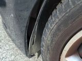 a close up of a car ' s front tire with the rim missing