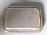 a silver tray with a lid on a white surface