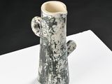 a black and white vase with a cactus on it