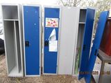 three blue lockers next to each other in a parking lot