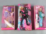 three barbie dolls are lined up in a row on a table