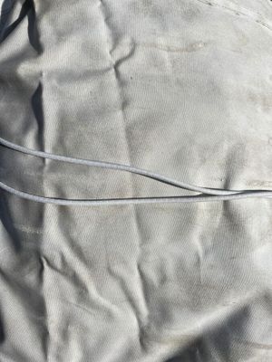 a bag that is sitting on the ground next to a pair of scissors