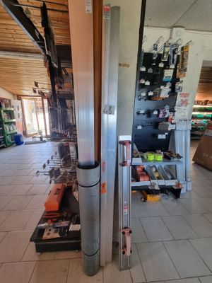 a refrigerator in the middle of a room with a lot of items on the floor