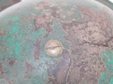 a close up of a helmet with a metal button on it