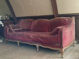 a couch that is sitting in a room with wood floors