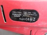 a close up of a red machine with a label on it