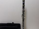 a clarinet that is sitting on a table next to a case