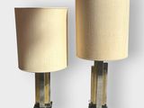 pair of brass and glass table lamps with lampshads on bases