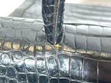 a close up of a black purse with a handle