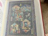 someone is holding a book with a picture of a nativity scene in it