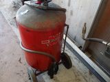 a red fire extinguisor with a bucket on top of it