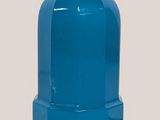 a blue glass vase with a gold base on a table