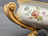a vase with flowers on it sitting on a table