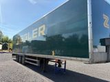 a large green trailer that is parked in the parking lot