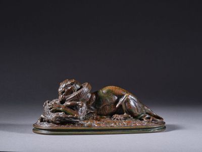 une statue en bronze représentant un chien couché sur le dos
