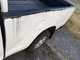 a white truck that is parked on the side of the road