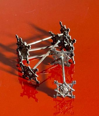 a close up of a pair of scissors on a red surface
