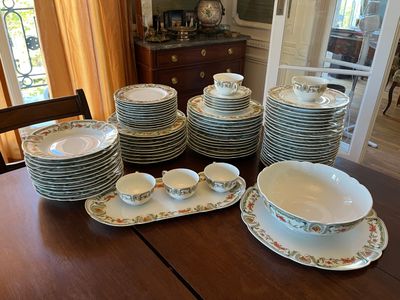 a lot of plates and bowls on the table