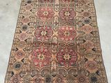 a large antique persian rug with a red and blue design