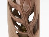 a brown vase with a leaf design on it