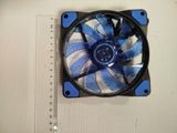 a blue and black fan on a white surface next to a ruler
