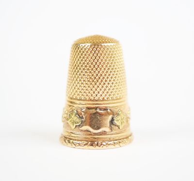 an image of a gold thimble on a white background