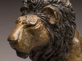 statue of a lion on a pedestal with a gray background