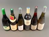 several bottles of wine are lined up in a row on a table
