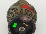 an image of a metal object with a green sticker on it