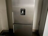 a silver refrigerator and a silver refrigerator freezer in a kitchen
