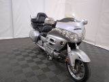 a silver motorcycle that is parked on a black and white checkered floor