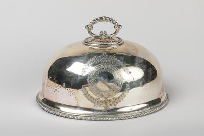 a silver plate with a silver lid on a white background