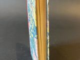 a small book that has a picture of a dragon on it