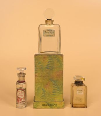 two small bottles of perfume sitting next to each other on a table
