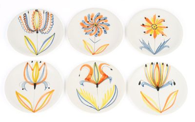 six plates with different designs of flowers on them on a white surface