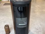 a black trash can sitting in the middle of a room