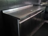 stainless steel counter top in a commercial kitchen with tiled walls
