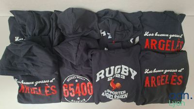 a group of t - shirts that are sitting on top of a table