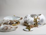 two ceramic animals sitting next to each other on a table