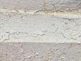 a close up of a piece of wood with peeling paint on it