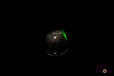 an image of a black and green orb in the dark